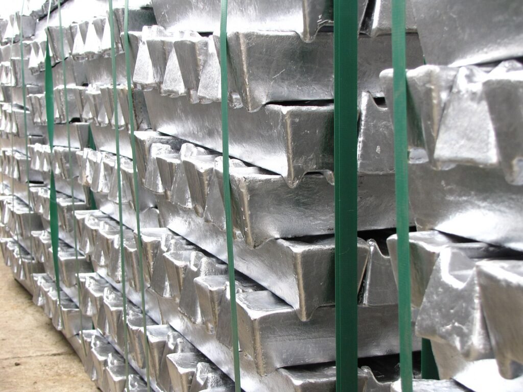 Bundled aluminium ingots stored on an industrial floor.