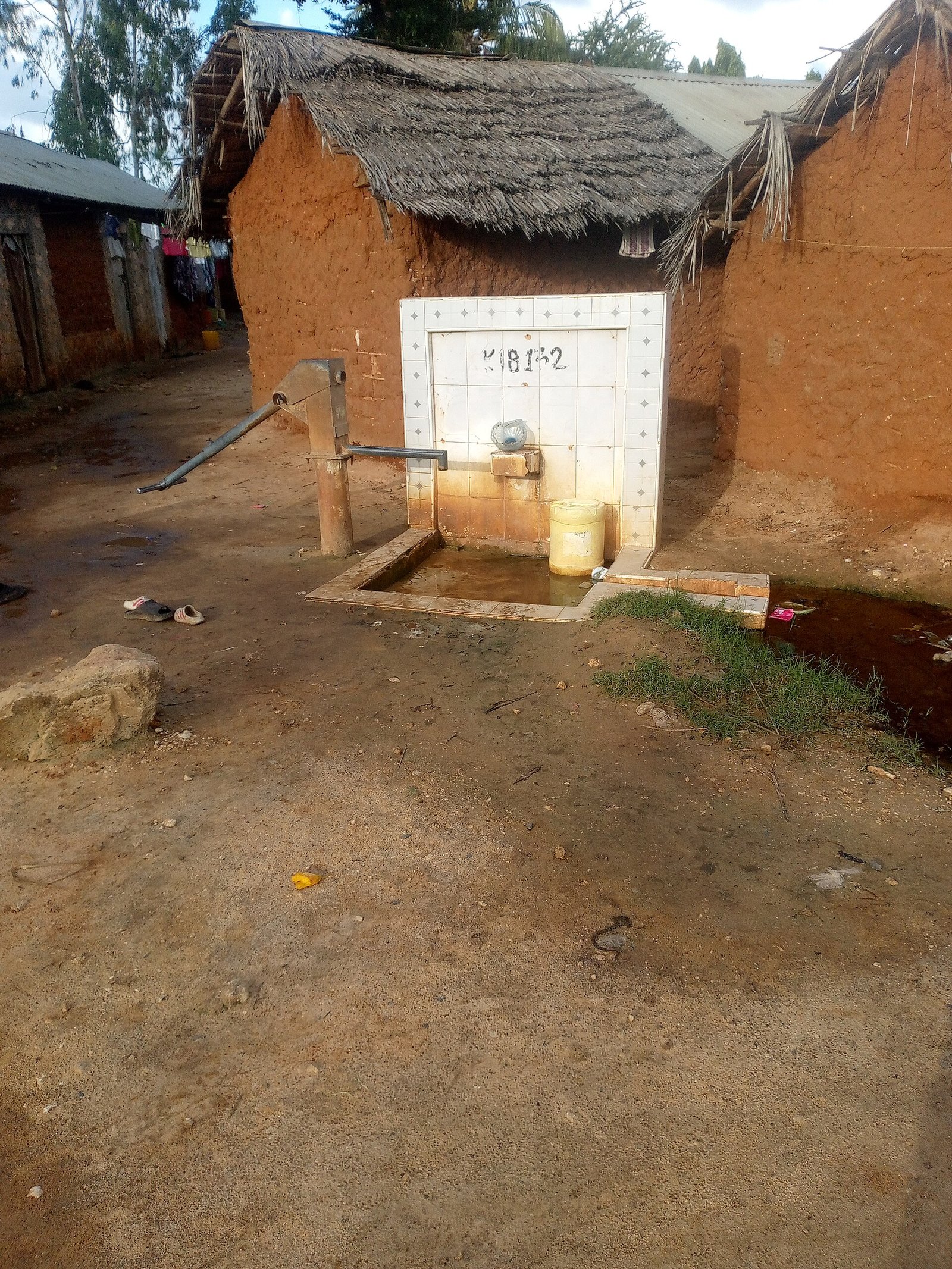 A hand-pump borehole and collection area in Kilifi, Kenya; representative borehole photography.