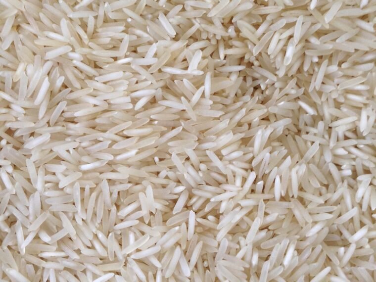 Uncooked long-grain rice photographed in close-up.