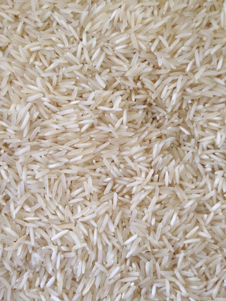 Uncooked long-grain rice photographed in close-up.