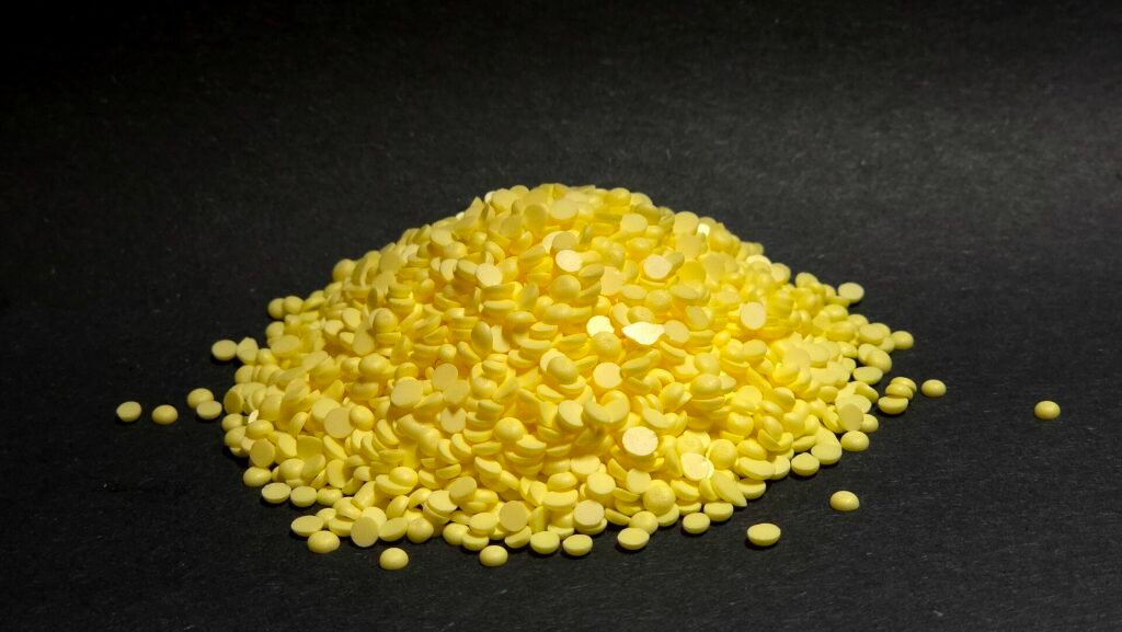 Solid elemental sulphur granules photographed in close-up.