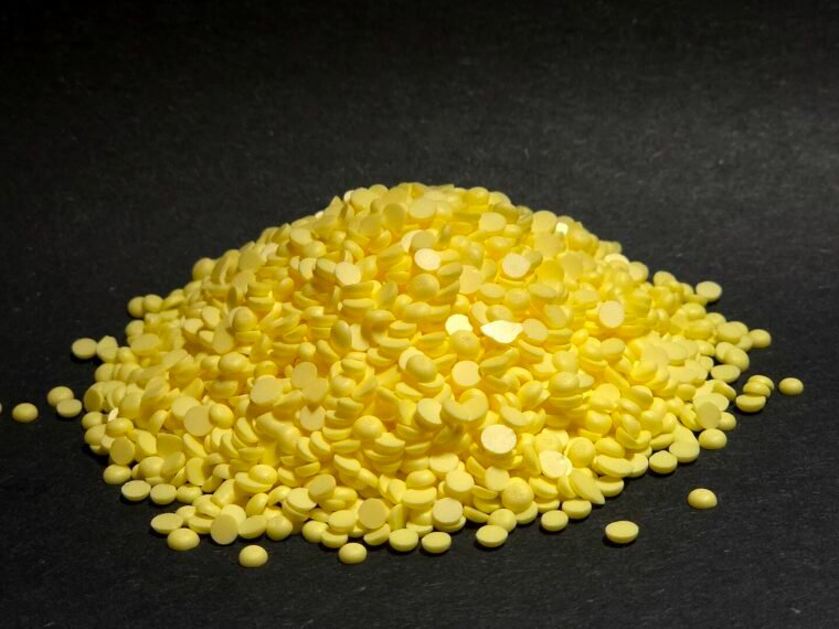 Solid elemental sulphur granules photographed in close-up.