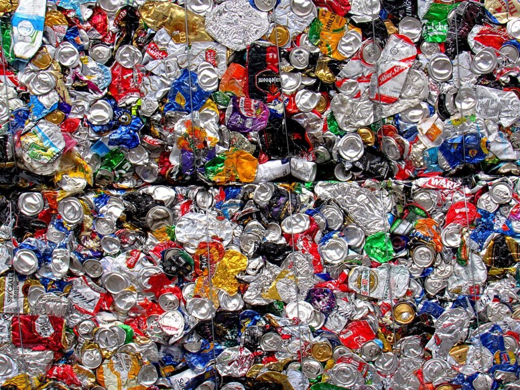Bales of used aluminium beverage cans at a recycling facility.
